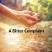 Human hand cupped to catch the fresh water from the river, reflection on water surface.